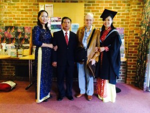 Mỹ Hoa's graduation photo. Mỹ Hoa 's parents on the left, me, then Mỹ Hoa and her mother wearing traditional Vietnamese dress and Mỹ Hoa in her academic gown.